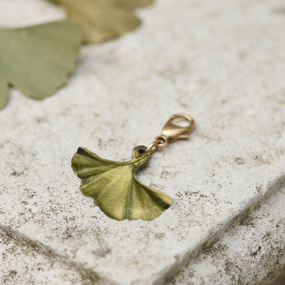 Michael Michaud Ginkgo charm with green patinated finish in an elegant French garden setting