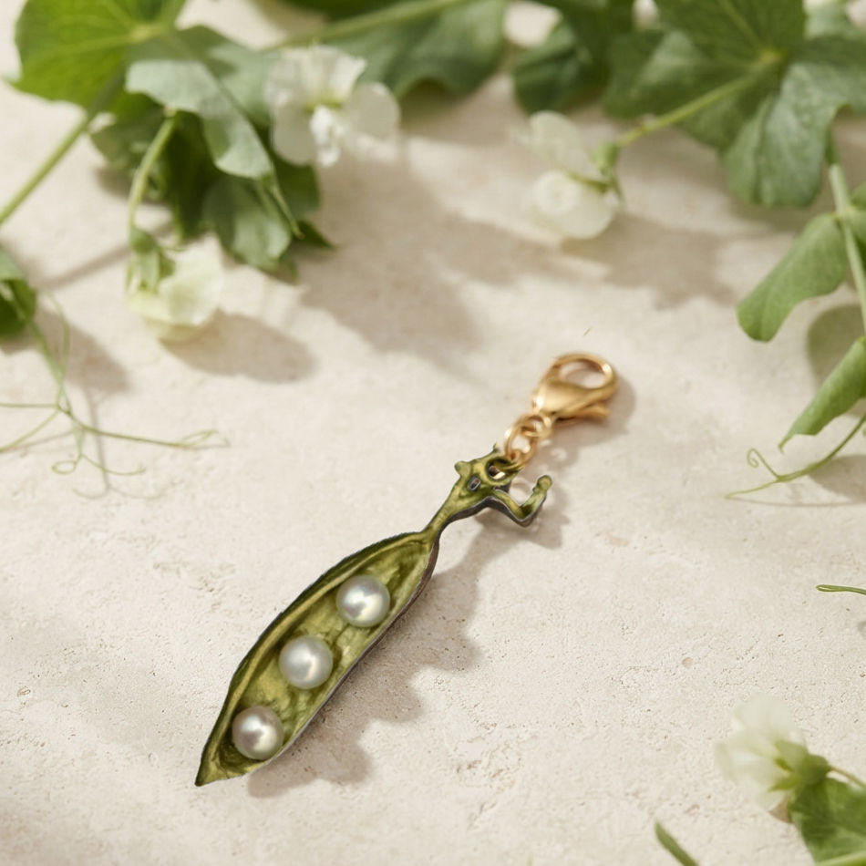 Michael Michaud Peapod charm with freshwater pearls on French limestone with pea vines
