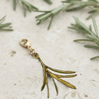 Michael Michaud Rosemary charm on limestone with fresh rosemary sprigs