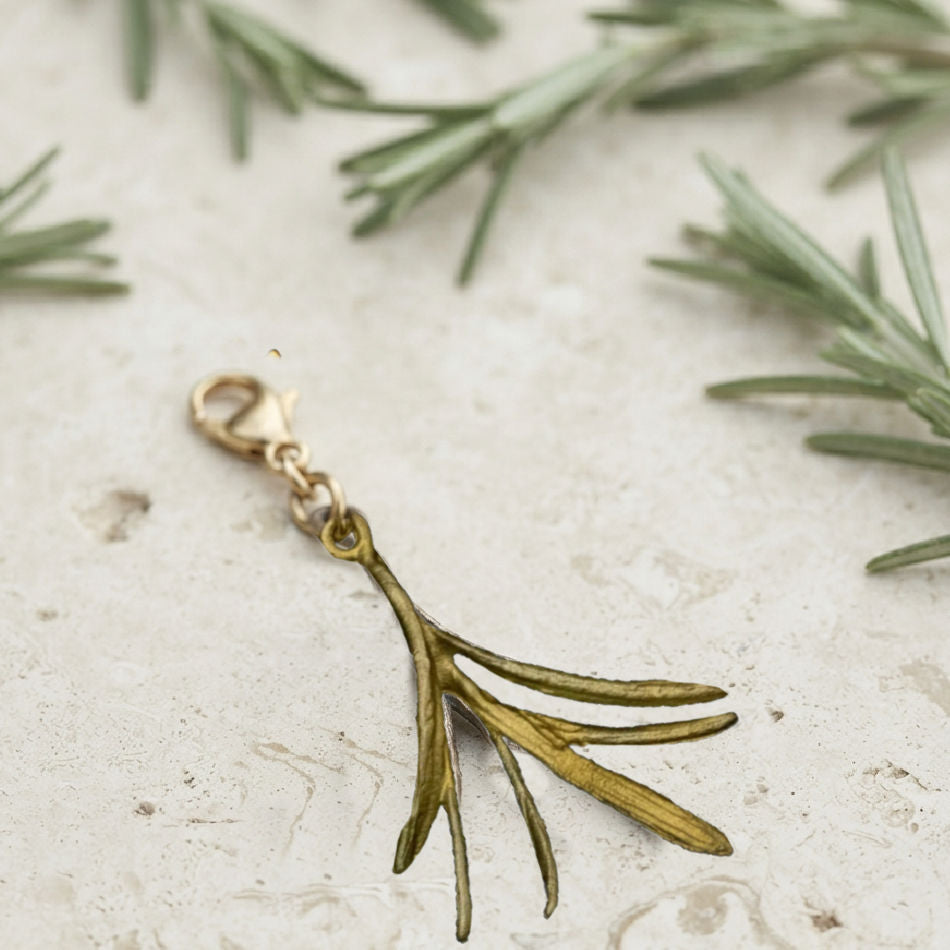 Michael Michaud Rosemary charm on limestone with fresh rosemary sprigs