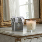 Luxury French scented candle with gift box displayed on an elegant marble table