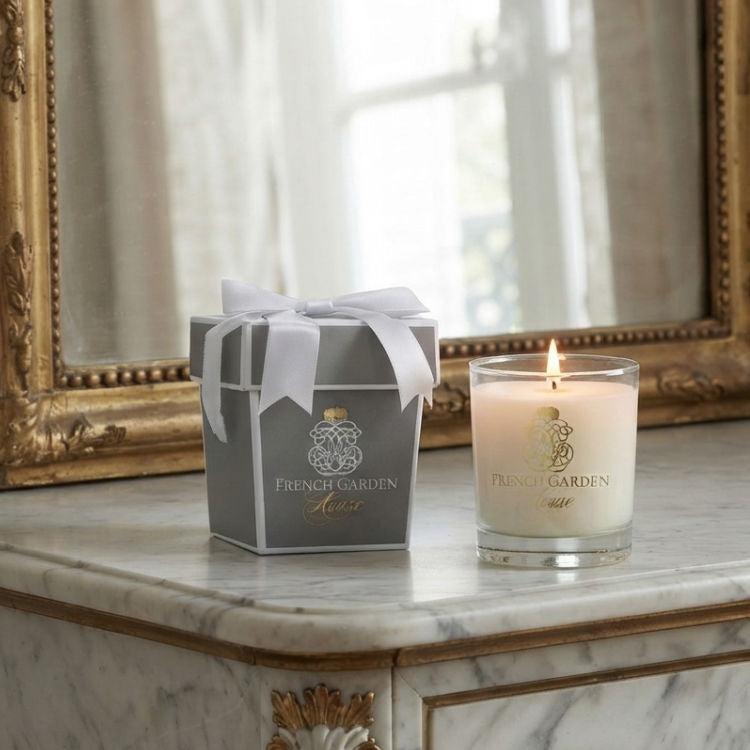 Luxury French scented candle with gift box displayed on an elegant marble table