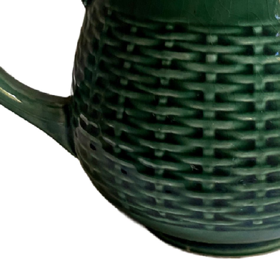 Close-up of glossy green glaze on antique French basketweave pitcher