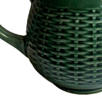 Close-up of glossy green glaze on antique French basketweave pitcher