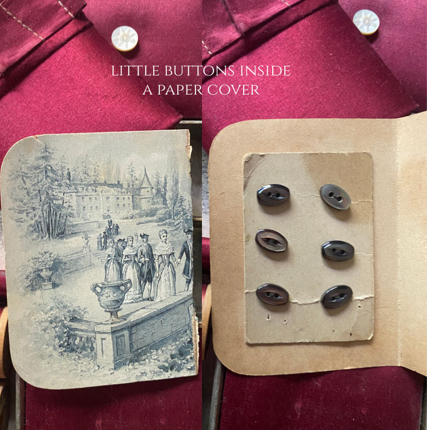 Opened Victorian collector sewing box displaying pink silk compartments and paper sleeve and antique buttons original contents