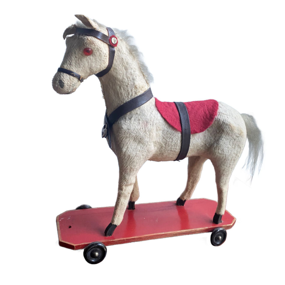 Early 1900’s antique cream horse pull toy with red platform