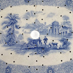 Early English ceramic strainer drainer, top‑down view showing shepherds and river scene pattern