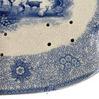 Close up of floral and seaweed border on early 1800s blue and white strainer drainer