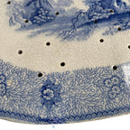 Close up of floral and seaweed border on early 1800s blue and white drainer repaired long ago