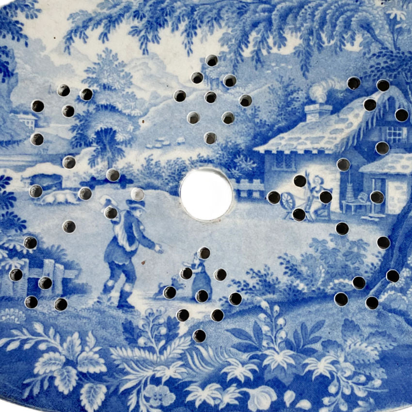 Brameld Mazarin strainer, Yorkshire blue and white transferware, top-down view showing pastoral design