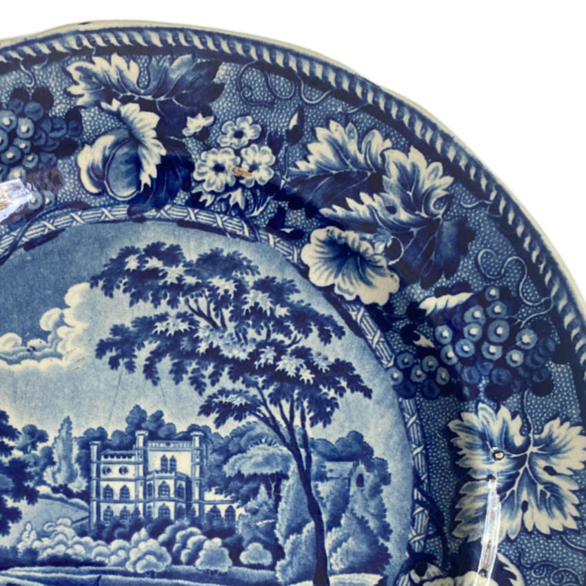 Antique Staffordshire historical blue and white decorative plate with landscape design on a white background 