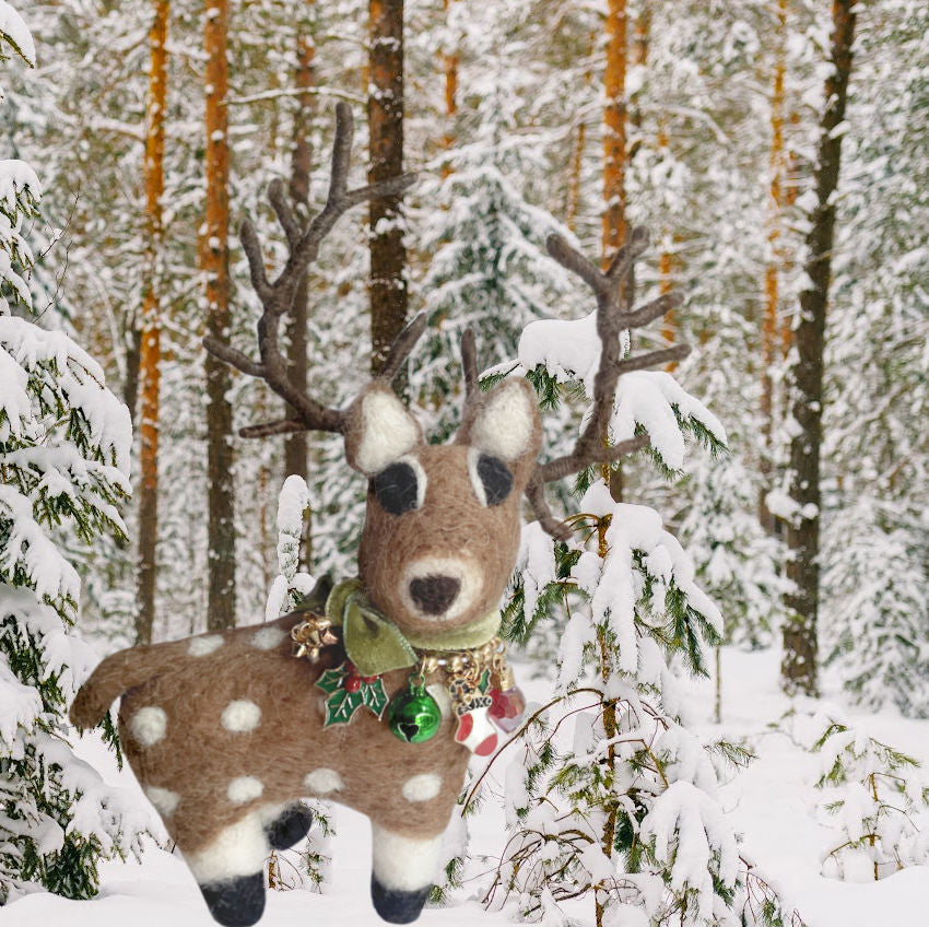 Our Éclair Holiday Felted Reindeer with Charms Ornament is a stylish young lady. Wearing a christmas charm necklace with enameled charms and a green bell