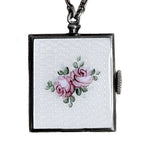 Edwardian sterling silver watch pin with white guilloché enamel, hand-painted roses and bow motif, a refined early 20th century jewel.