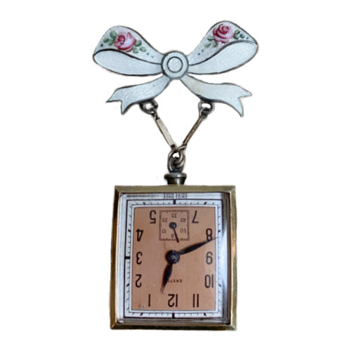 Edwardian sterling silver watch pin with white guilloché enamel, hand-painted roses and bow motif, a refined early 20th century jewel.