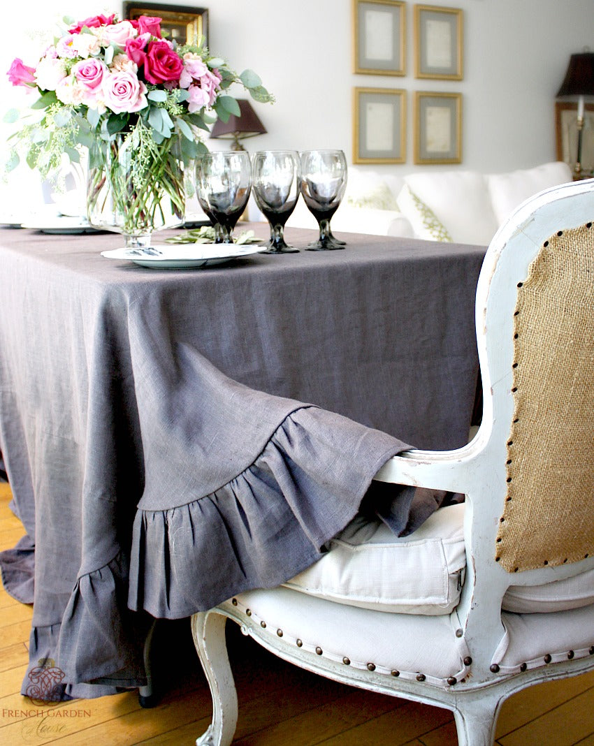 Elegant French Country dining table with grey linen round tablecloth
