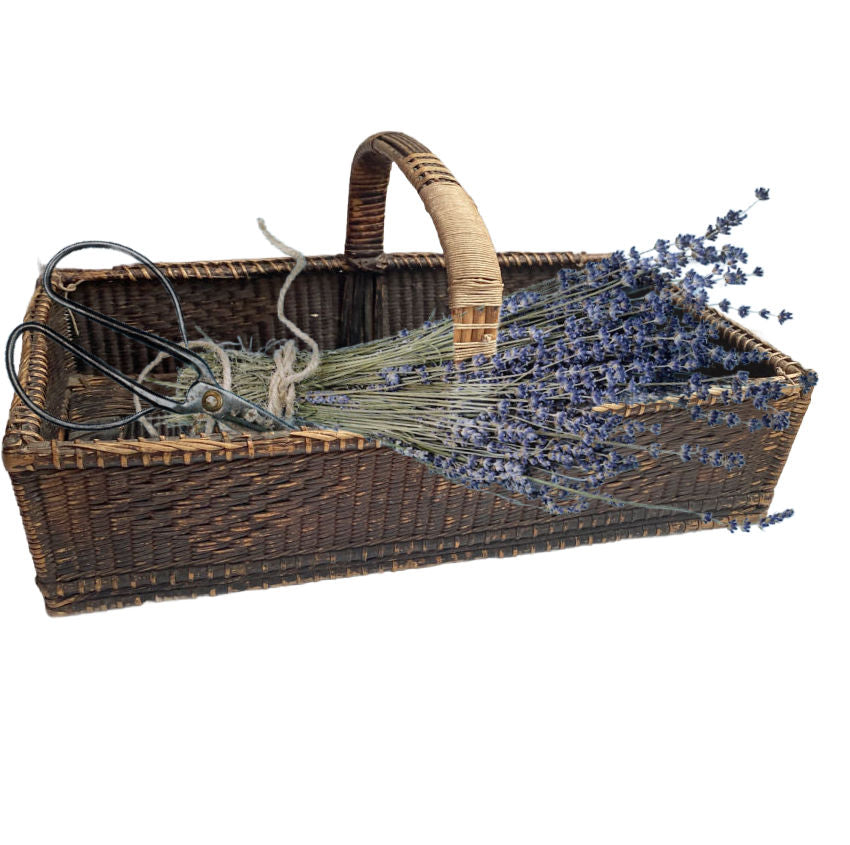 A rare and soulful 19th Century Antique Shallow Handwoven Basket woven by hand with remarkable skill and artistry. Once used for holding flatware or linens, this beautifully aged piece bears the marks of time with quiet grace. Its dark, time-worn patina and exquisite texture tell the story of generations past, while the old string repairs—done with care long ago—reveal the devotion of those who cherished and preserved it.