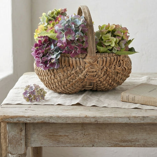 Antique French Hand-Woven Panier à Fesses, Antique Splint Basket with hydrangeas on a french table