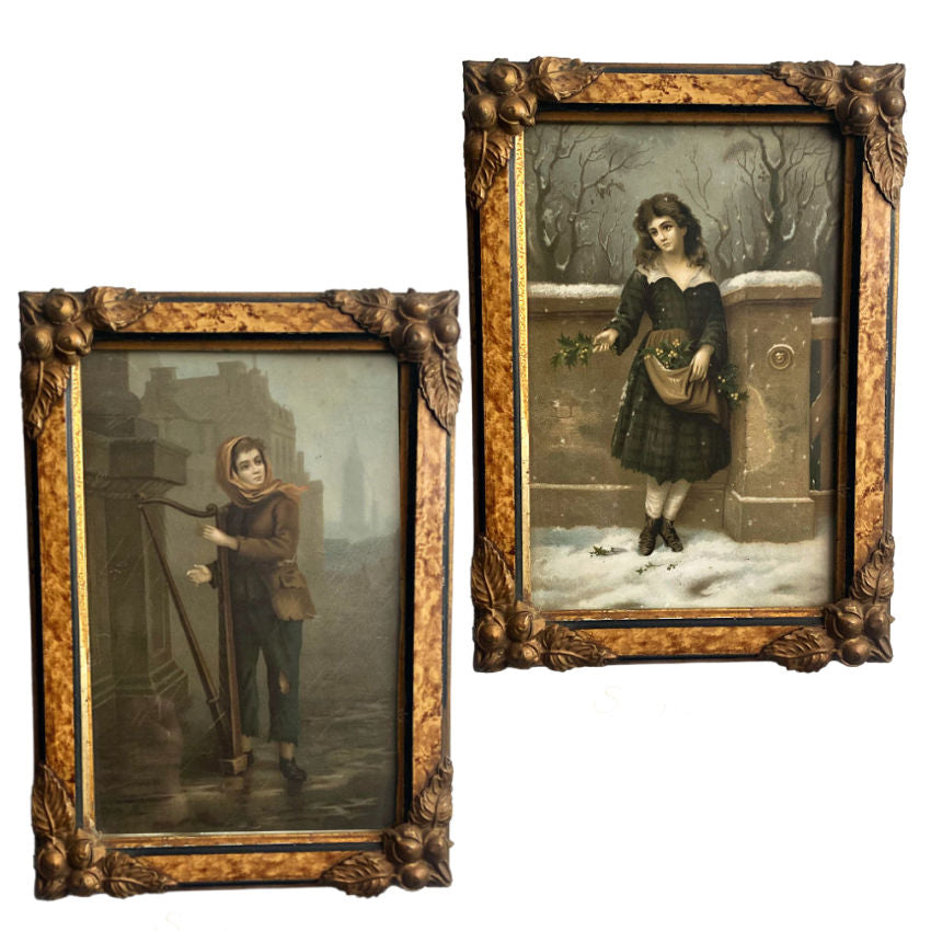 Two antique 19th century color lithographs, one depicting a girl selling holly in winter and the other showing a young person playing the harp in the rain, both framed in ornate gilded frames.