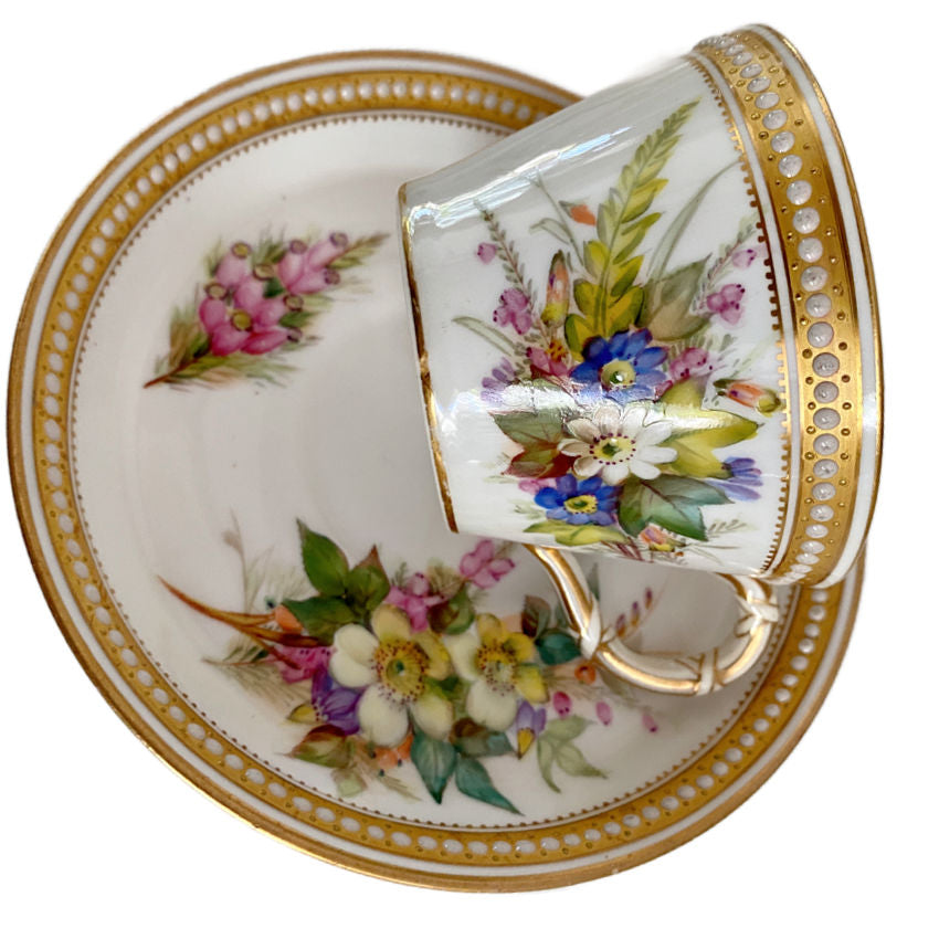 Antique Royal Worcester saucer showing hand-painted floral decoration, jeweled enamel details, and gilt trim