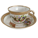 Antique Royal Worcester porcelain tea cup with individually hand-painted flowers, raised jeweled enamel decoration, and elegant gilded details.