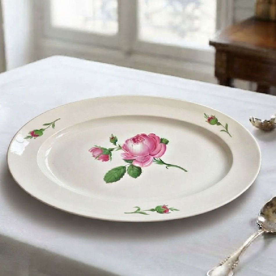 Antique Meissen serving platter with hand-painted pink roses on an elegant dining table