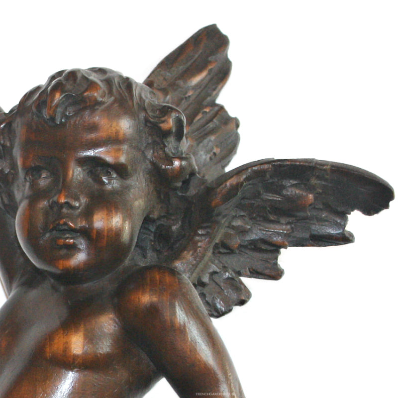 Antique pair of Baroque angel figures carved in wood with expressive faces and flowing wings- close up view