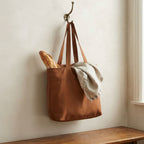 French Country amber bronze linen tote bag hanging from antique wall hook