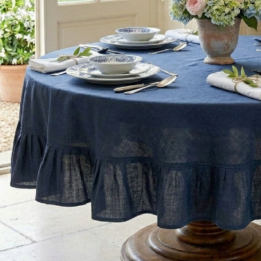 Close detail of ruffled hem on deep blue luxury linen tablecloth 90 inch
