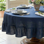 Close detail of ruffled hem on deep blue luxury linen tablecloth 90 inch