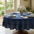 Elegant French Country dining table set with navy linen round tablecloth