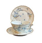 Early 20th century Haviland Limoges Montméry tea trio with blue forget-me-not florals and softly scalloped gilt edges.