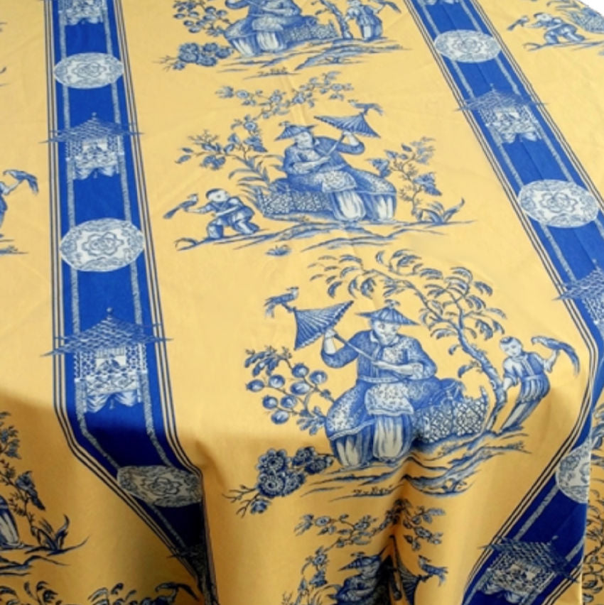 Authentic French cotton tablecloth in yellow and blue chinoiserie. Made in France,folded to show all the designs.