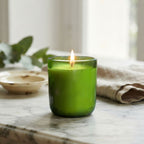 FrenchGardenHouse luxury scented candle in green glass displayed on an elegant antique marble table