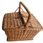 Rustic French willow basket with handle, two openings, and leather strap closure