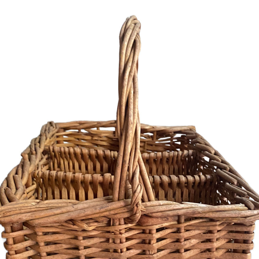 close detail of braided willow compartments and thick handle  in antique French handwoven wine carrier