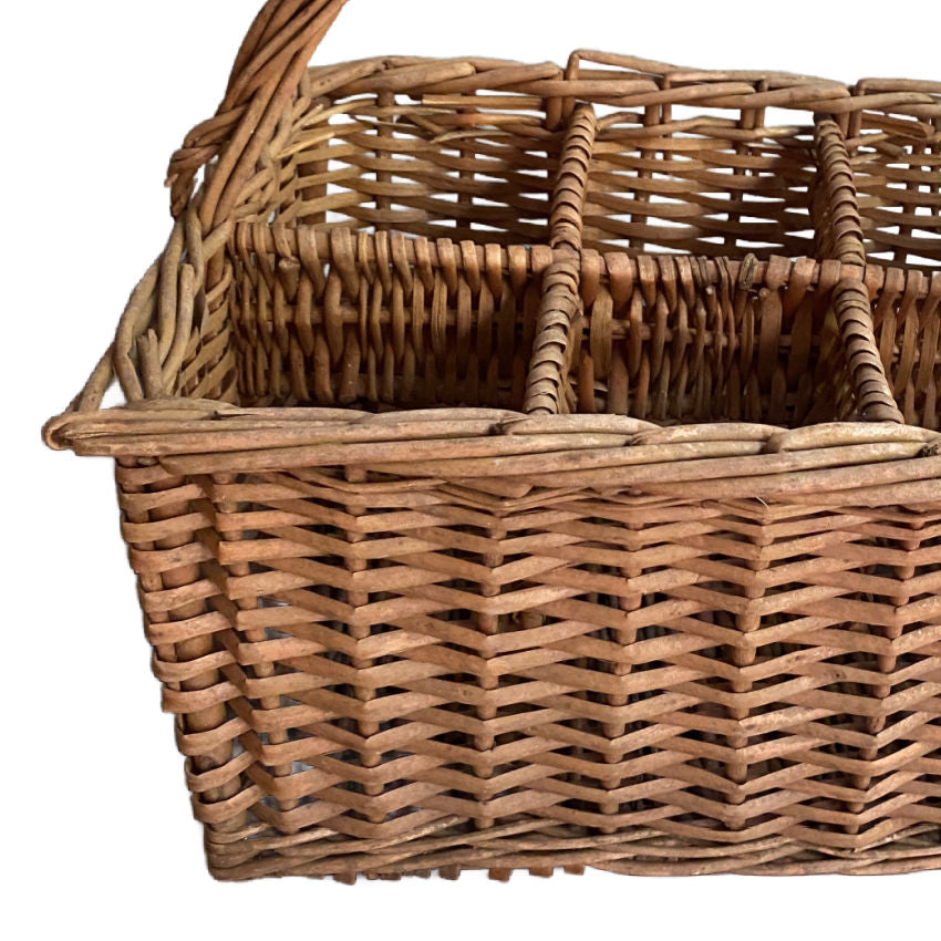 close detail of braided willow compartments inantique French country  handwoven wine carrier