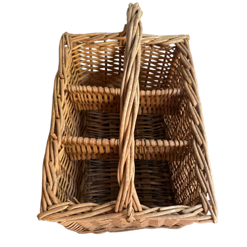 top view of french country vineyard basket holding wine bottles in warm natural light