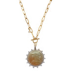 French coin medallion necklace on a bold gold paperclip chain. Elegant, sculptural and timeless with refined European appeal.