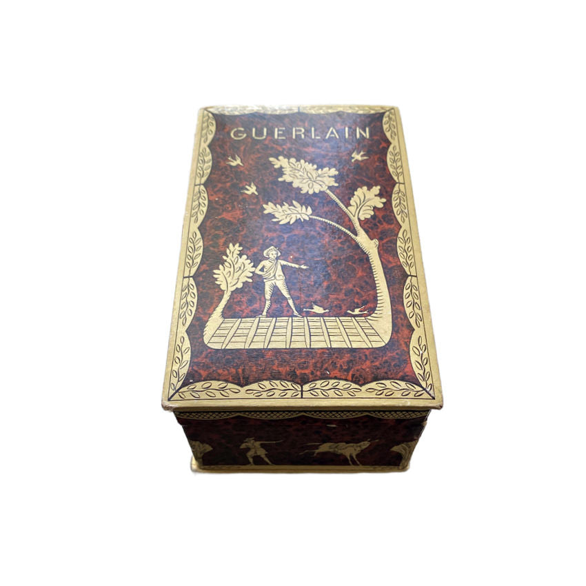 A vintage French Guerlain Parquet perfume box with a burled wood pattern, featuring a figure and leaf motifs, and the brand name 'GUERLAIN' at the top.