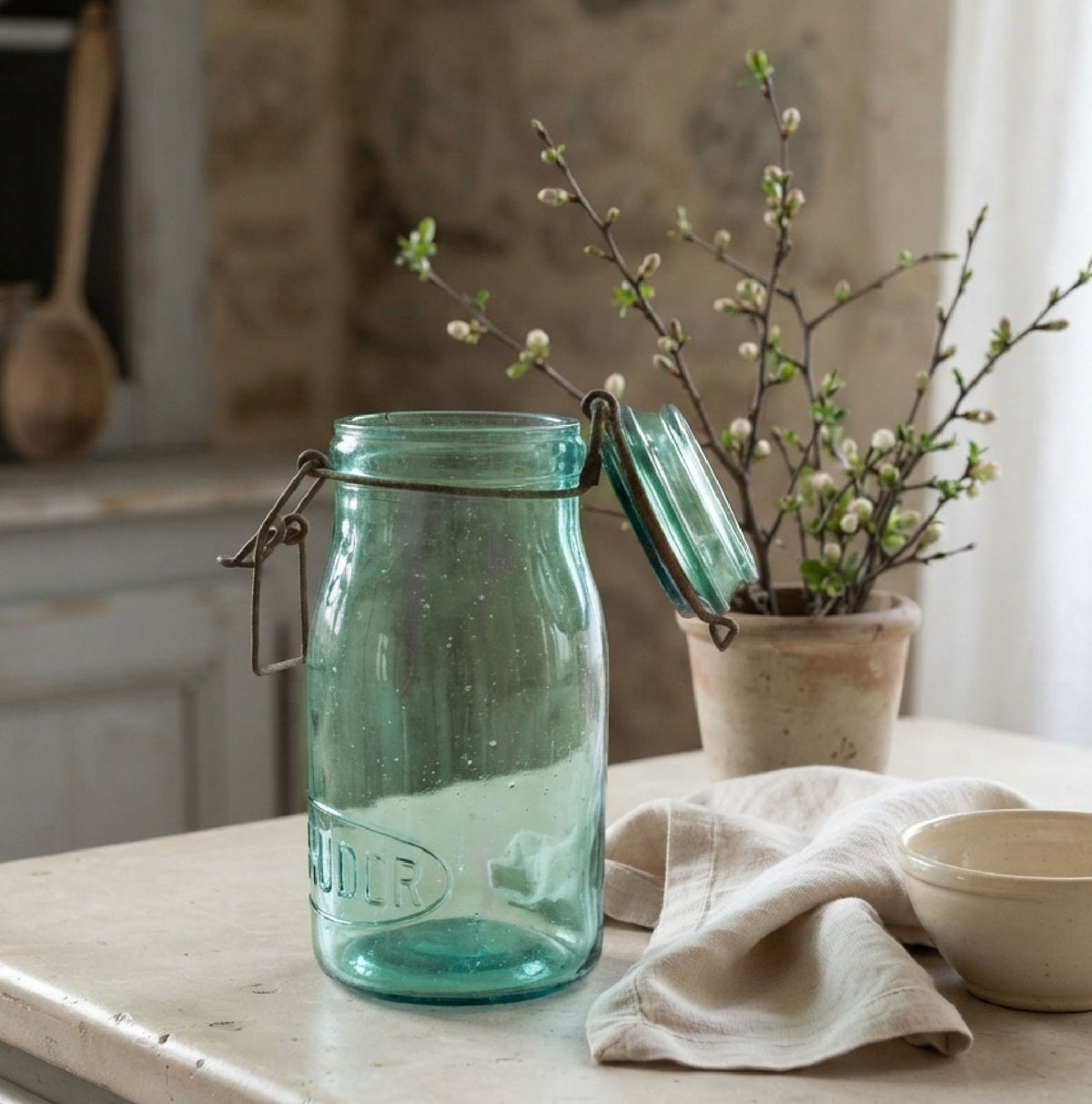 Antique French aqua preserving jar displayed on a collected French Country kitchen counter