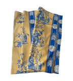 Authentic French cotton tablecloth in yellow and blue chinoiserie. Made in France,folded to show all the designs.