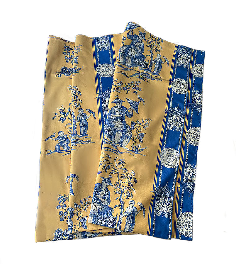 Authentic French cotton tablecloth in yellow and blue chinoiserie. Made in France,folded to show all the designs.