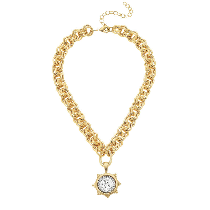 A gold-plated chain necklace featuring a central silver-plated coin with an intricate design, resembling a bee.
