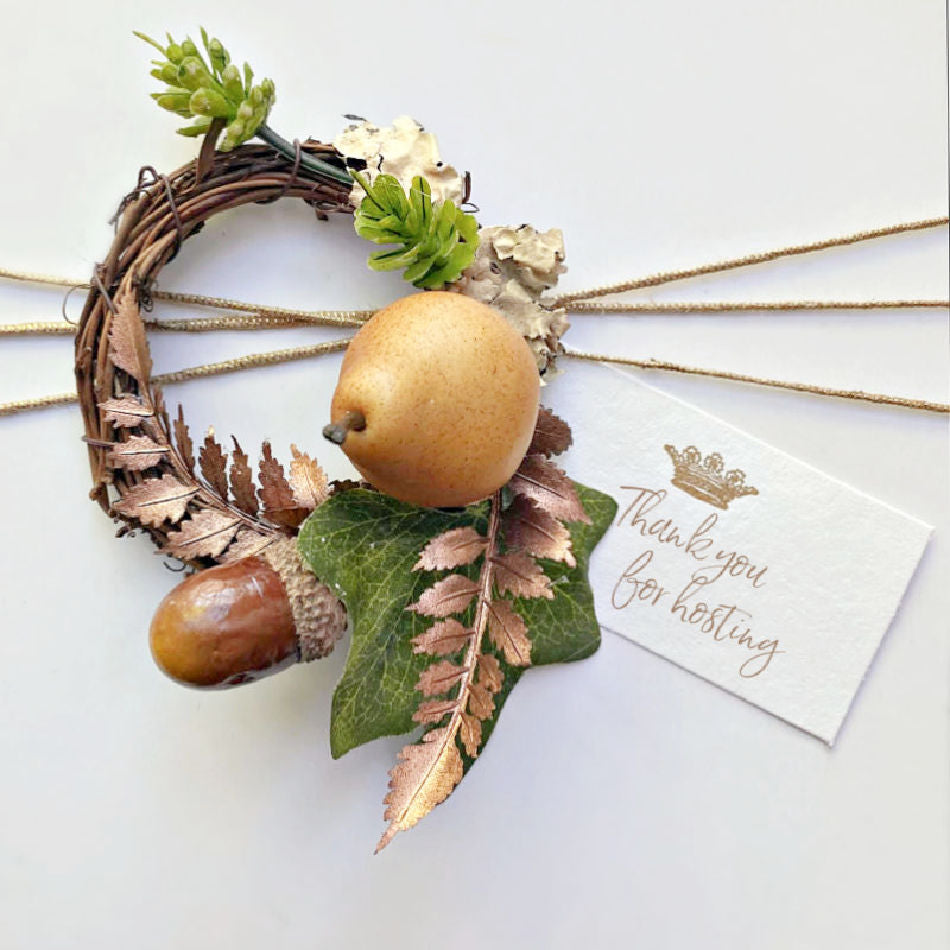 Gold twine gift wrap set with little cards and a wreath with a pear and bronze ferns