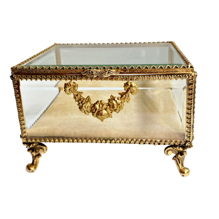 A rare gilt jewelry casket featuring heavy beveled glass panels, Rococo-style feet, and delicate rose garland detailing, and the original cushion. A luxurious collector’s gem, perfect for keepsakes or jewelry display.