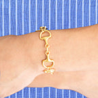 Hand cast with triple plated 24 kt gold bracelet with links, toggle closure.