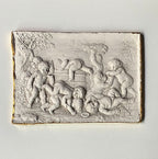 Close detail of cherub relief showing soft aged plaster surface