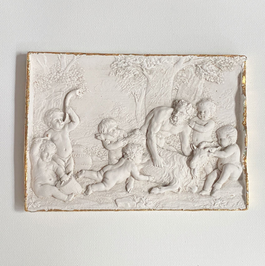 Grand Tour inspired classical myth relief artwork cherubs with satyr decorative gallery wall panel close up view