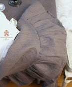 Close detail of deep ruffle hem on luxury grey linen tablecloth 90 inch