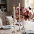 French Cream beeswax taper candles glowing on an elegant dining table with fresh flowers and antique silver